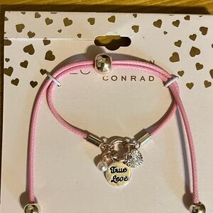 Brand new Lauren Conrad pink adjustable bracelet with True love charm